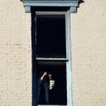 A visitor snaps a photo from the third floor window of the old Dixieland shoe store on the corner of...