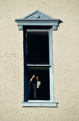 
                               
                                  Photo by Michael Woods&mdash;
                               
                           
                           A visitor snaps a photo from the third floor window of the old Dixieland shoe store on the corner of Walnut and 1st street in Rogers during a tour of the building Wednesday morning.  John Mack, owner of JKJ Architects, recently purchase the former Dixieland Shoe store on the corner of First and Walnut street. He is restoring the building which includes the Opera House on the second floor, once a grand theater.