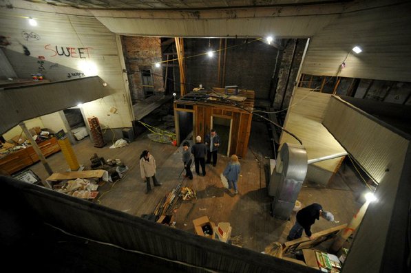 
                               
                                  Photo by Michael Woods&mdash;
                               
                           
                           Visitors take a look around the old opera house on the second floor of the old Dixieland shoe store on the corner of Walnut and 1st street in Rogers Wednesday morning.  John Mack, owner of JKJ Architects, recently purchase the former Dixieland Shoe store. He is restoring the building which includes the Opera House on the second floor, once a grand theater.