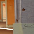A post-it note hangs on the wall in one of the rooms in need of restoration at the old opera house o...