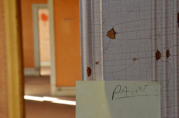 
                               
                                  Photo by Michael Woods&mdash;
                               
                           
                           A post-it note hangs on the wall in one of the rooms in need of restoration at the old opera house on the second floor of the old Dixieland shoe store on the corner of Walnut and 1st street in Rogers Wednesday morning.  John Mack, owner of JKJ Architects, recently purchase the former Dixieland Shoe store. He is restoring the building which includes the Opera House on the second floor, once a grand theater.