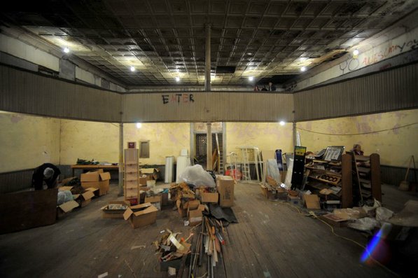 
                               
                                  Photo by Michael Woods&mdash;
                               
                           
                           Visitors take a look around the balcony of the old opera house on the second floor of the old Dixieland shoe store on the corner of Walnut and 1st street in Rogers Wednesday morning.  John Mack, owner of JKJ Architects, recently purchase the former Dixieland Shoe store. He is restoring the building which includes the Opera House on the second floor, once a grand theater.