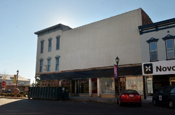 
                               
                                  Photo by Michael Woods&mdash;
                               
                           
                           The old Dixieland shoe store on the corner of Walnut and 1st street in Rogers Wednesday morning.  John Mack, owner of JKJ Architects, recently purchase the former Dixieland Shoe store on the corner of First and Walnut street. He is restoring the building which includes the Opera House on the second floor, once a grand theater.
