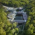 Designed by Moshe Safdie, the multiple buildings of Crystal Bridges Museum nestle seamlessly into th...