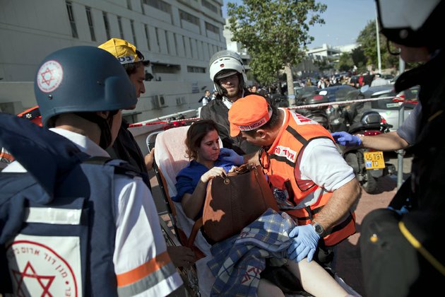 israeli-rescue-workers-and-paramedics-carry-an-injured-woman-from-the-site-of-a-bombing-in-tel-aviv-israel-on-wednesday-nov-21-2012