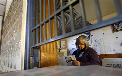 in-this-phot-taken-on-dec-15-2011-postmaster-antoinette-benthusen-sorts-mail-shortly-after-opening-at-the-post-office-in-powder-river-wyo-the-small-rural-post-office-was-one-of-43-in-wyoming-being-considered-for-closure-by-the-us-postal-service-as-a-cost-saving-measure