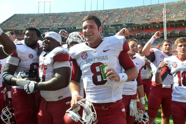 Gene Chizik’s Auburn Tigers had all the momentum from a national championship season and the accompanying exposure, and stockpiled highly rated recruits to keep the success going. The Tigers were beaten 24-7 by a struggling Razorbacks team and then things got even worse. Shown University of Arkansas quarterback Tyler Wilson celebrates with his team following the Razorbacks win over Auburn.