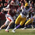 NWA Media/ANDY SHUPE -- Arkansas quarterback Tyler Wilson (8) look to pass while being pursued by LS...
