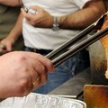 Maudie Schmitt checks on a fried turkey leg at her restaurant in Fayetteville. 