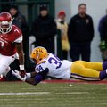 NWA Media/JASON IVESTER -- Arkansas running back Knile Davis slips past a tackle attempt from LSU sa...