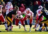 Nebraska running back Rex Burkhead (22) runs for a first down past Iowa’s Louis Trinca-Pasat (left) and Collin Sleeper (right) during the second half of the No. 14 Cornhuskers’ 13-7 victory over the Hawkeyes on Friday in Iowa City, Iowa. 
