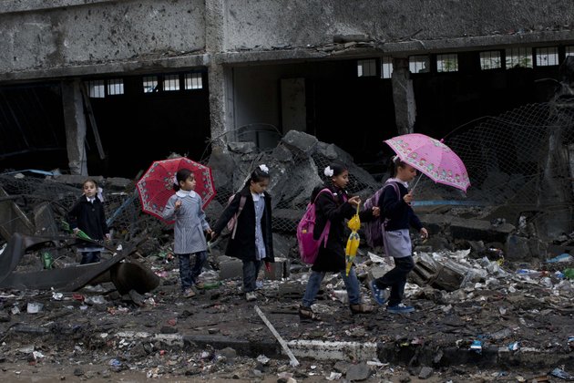 palestinian-schoolchildren-walk-in-debris-by-a-damaged-school-in-gaza-city-saturday-nov-24-2012-schools-in-gaza-opened-saturday-for-the-first-time-since-the-truce-which-calls-for-an-end-to-gaza-rocket-fire-on-israel-and-israeli-airstrikes-on-gaza-came-after-eight-days-of-cross-border-fighting-the-bloodiest-between-israel-and-hamas-in-four-years-the-school-was-damaged-when-israeli-forces-struck-on-a-nearby-building