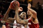 Arkansas' Coty Clarke (4) looks to make a shot with Wisconsin's Ryan Evans (5) defending during the second half of an NCAA college basketball game at the Continental Tire Las Vegas Invitational tournament on Saturday, Nov. 24, 2012, in Las Vegas. Wisconsin won 77-70. (AP Photo/David Becker)