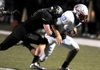 Bentonville linebacker Garrett Kaufman (left) tackles Fort Smith Southside quarterback Isaac Jackson during Friday night’s Class 7A playoff game. 