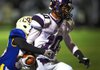 Fayetteville’s Jordan Dennis (right) crosses the goal line for a touchdown with North Little Rock’s Martinez Butler in tow during Friday night’s Class 7A playoff game. 