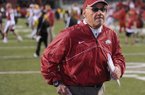 NWA Media/ANDY SHUPE
Arkansas coach John L. Smith runs off the field Friday, Nov. 23, 2012, after the Hogs' 20-13 loss to LSU at Razorback Stadium.