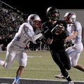 Nate Gneiting, Bentonville senior wide receiver, catches a touchdown Friday at Tiger Stadium. 