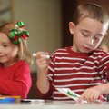 Devin Brewer, 6, right, and sister, Abby Brewer, 5, both of Fayetteville, color in holiday cards Sat...