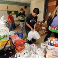 Natalie Counce, right, a junior at Fayetteville High School, and sophomore Nico Suarez, center, help...