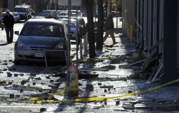 people-walk-in-a-damaged-area-about-a-block-away-from-the-site-of-a-friday-evening-gas-explosion-that-leveled-a-strip-club-in-springfield-mass-saturday-nov-24-2012-investigators-are-trying-to-figure-out-what-caused-the-blast-where-the-multistory-brick-building-housing-scores-gentlemans-club-once-stood