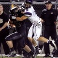 Alex Brignoni, Fayetteville senior defensive back, brings down Bentonville senior running back Garre...