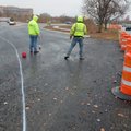 Construction crews mark the lines around the new traffic circle at the intersection of East Millsap ...