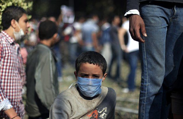 an-egyptian-boy-wears-a-mask-during-clashes-security-forces-near-tahrir-square-where-an-opposition-rally-has-been-called-for-to-voice-rejection-of-president-mohammed-morsis-seizure-of-near-absolute-powers-in-cairo-on-tuesday-nov-27-2012