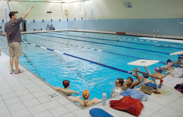 head-coach-chad-price-left-instructs-the-searcy-based-sharks-swim-team-during-practice-price-works-with-the-teams-state-and-national-level-swimmers