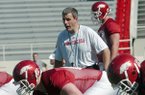 Arkansas Democrat-Gazette/MICHAEL WOODS -- Arkansas offensive line coach Chris Klenakis works with the offensive line during a 2010 practice at Razorback Stadium in Fayetteville.