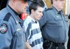 Deputies escort Zachary Holly to a patrol car Wednesday after a bail hearing at the Benton County Courthouse in Bentonville. Holly is charged in the death of Jersey Bridgeman, 6. 