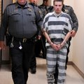 Zachary Holly, 28, of Bentonville is escorted Wednesday by Benton County Sheriff’s Office deputies i...