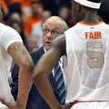 Syracuse head coach Jim Boeheim, center, talks with his players during a timeout against Princeton i...