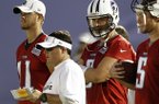 In this July 29, 2012, file photo, Tennessee Titans quarterbacks coach Dowell Loggains, front, watches quarterbacks Rusty Smith (11), Matt Hasselbeck, (8) and Nick Stephens (5) during NFL football camp in Nashville, Tenn. Titans head coach Mike Munchak fired offensive coordinator Chris Palmer on Monday, Nov. 26, 2012, and gave the job to Loggains, who will call his first NFL plays on Sunday when the Titans host the Houston Texans. (AP Photo/Wade Payne, File)