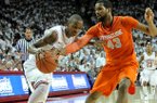 NWA Media/MICHAEL WOODS -- 11/30/2012-- Arkansas guard BJ Young tries to get past past Syracuse defender James Southerland during the first half of Friday night's game at Bud Walton Arena in Fayetteville