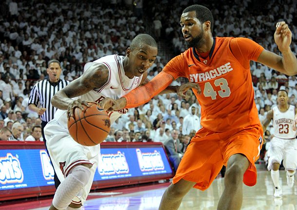 nwa-mediamichael-woods-11302012-arkansas-guard-bj-young-tries-to-get-past-past-syracuse-defender-james-southerland-during-the-first-half-of-friday-nights-game-at-bud-walton-arena-in-fayetteville