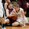 Taylor Lee, right, Bentonville senior, ties up a loose ball Thursday with Huntsville senior Sydney S...
