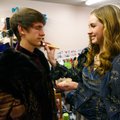 Lauren Suchy, Bentonville High School junior, helps senior Aaron Young with his makeup Thursday befo...