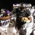 Tearris Wallace, a Bentonville senior running back, breaks through the Fayetteville defense during t...