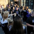 Fayetteville High School’s football team
accepts goody bags from cheerleaders as they leave the sch...