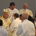 The Rev. Anthony B. Taylor, bishop of the Diocese of Little Rock, clasps hands with each deacon cand...