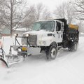 A snow plow clears a Bentonville neighborhood road Feb. 1, 2011. 