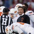 Oklahoma State coach Mike Gundy talks to an official during a timeout in the third quarter of an NCA...