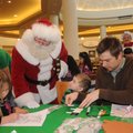 Savannah Kilpatrick, from left, Kynric Mullikin and his dad, Shanely Mullikin, become official Santa...
