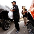 Danny Gutierrez, left, and Frank Delgado, both of Springdale, carry toys from their cars Saturday to...