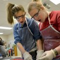 Avery Parker, right, and Golda Nunneley, both seventh-graders at Holt Middle School, react Thursday ...