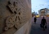 Pedestrians pass the UBS logo displayed outside the bank’s headquarters in Zurich, Switzerland in October. Switzerland’s biggest lender is said to be nearing a settlement with regulators over allegations traders tried to rig global interest rates. 