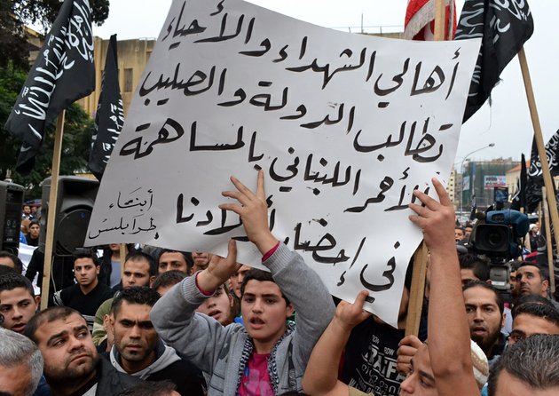 lebanese-supporters-of-islamic-group-hold-a-poster-with-arabic-that-reads-the-parents-of-the-martyrs-and-those-still-living-demand-the-republic-and-the-lebanese-red-cross-contribute-to-bring-our-children-during-a-protest-in-the-northern-city-of-tripoli-lebanon-on-monday-dec-3-2012