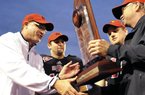 Arkansas State head coach Gus Malzahn, from left, quarterback Ryan Aplin and linebacker Nathan Herrold are presented with the Sun Belt Conference trophy following their NCAA college football game against Middle Tennessee on Saturday. Malzahn was hired as head coach at Auburn on Tuesday.