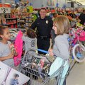 Liliana Cunningham, 6, left, shows Mindy Medina, police dispatcher, right, a movie she may want to p...