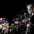 Jerri Grace Notestine, 5, (above) watches the Rogers Christmas Parade roll by Monday with her family...